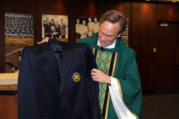 University president Rev. John I. Jenkins, C.S.C., admires his new Monogram Club blazer after being awarded an honorary monogram at the Notre Dame athletic department's opening Mass on Monday morning.