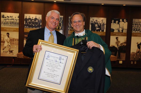 Past president of the Monogram Club Marc Kelly presents University President Rev. John I. Jenkins, C.S.C.