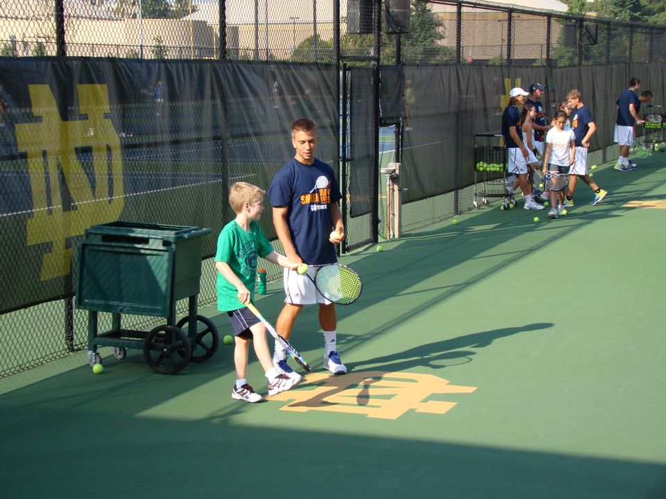 Senior Matt Dooley works with a youngster at the Smash MS clinic Saturday morning.