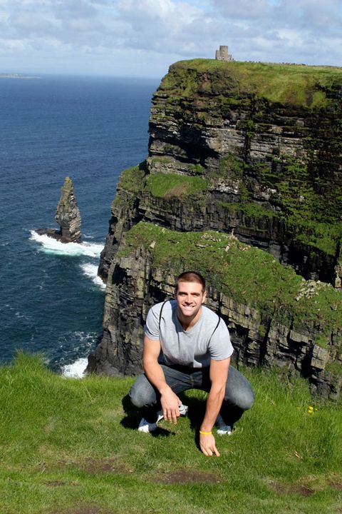 Senior guard Kyle McAlarney kneels on the edge of the Cliffs of Moher in Ireland on day 2 of the Notre Dame men's basketball team's foreign tour. <i>(photo by Tish Brey)</i>