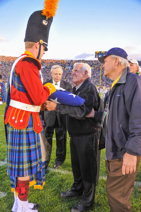 Legendary Notre Dame football head coach Ara Parseghian presented the flag prior to the Michigan game to commemorate the 125th anniversary of Notre Dame football (courtesy of Mike &amp; Susan Bennett).