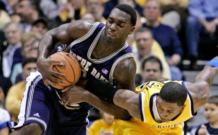 Marquette's Jerel McNeal fouls Torin Francis as they go after a loose ball during the first half. (AP Photo/Morry Gash)