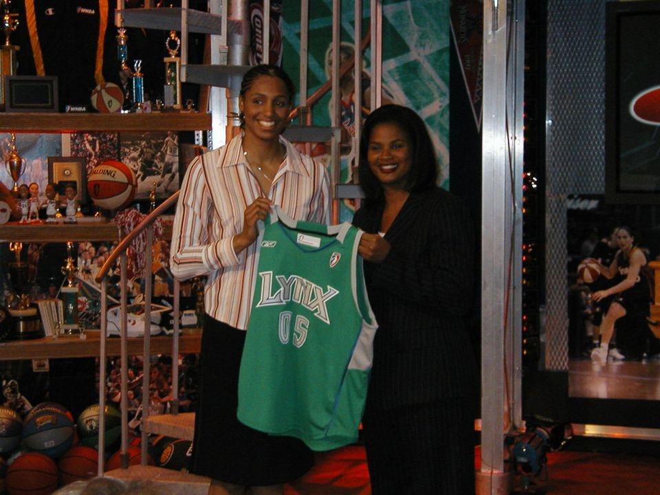 Notre Dame All-America forward Jacqueline Batteast shows off the colors of her new team, the Minnesota Lynx, after she was picked with the 17th overall selection in the 2005 WNBA Draft. (photo by Chris Masters)