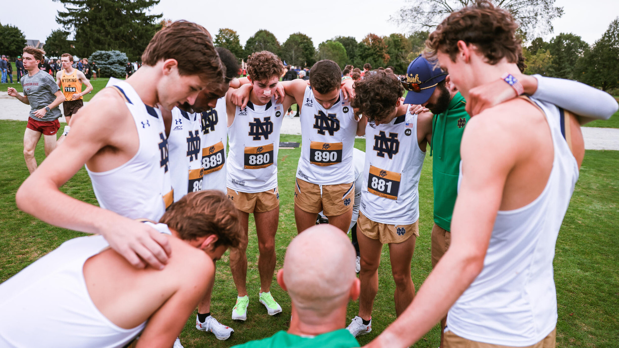 Men Defend Title, Women Take Third at Joe Piane Invite The men's team huddles together prior to the race.