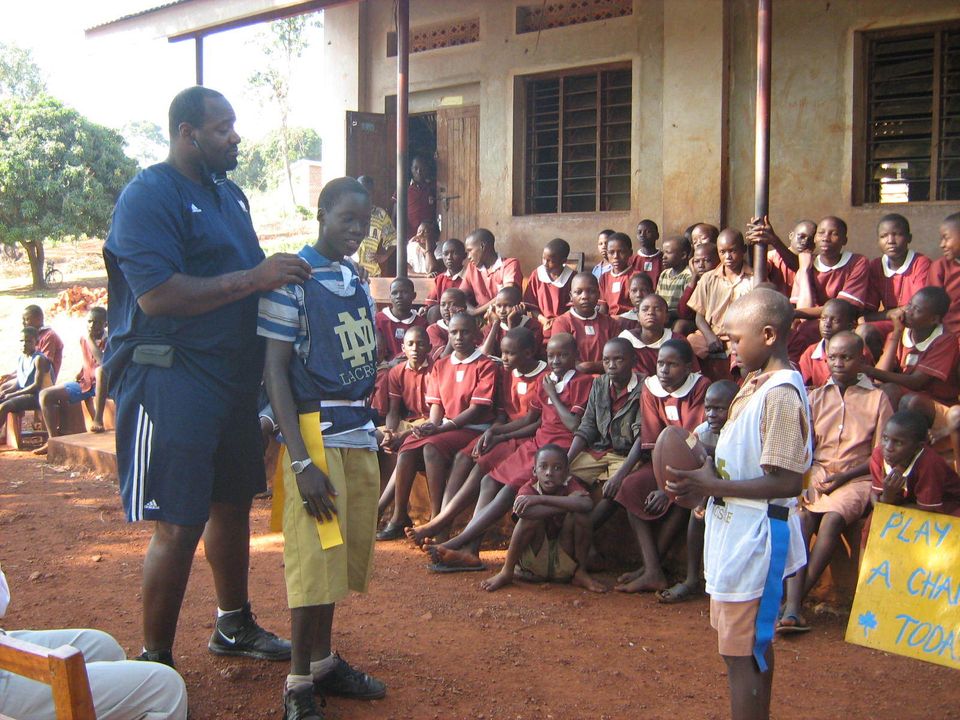 McBride instructs children at St. Jude's Primary School in Jinja about the rules of American football.