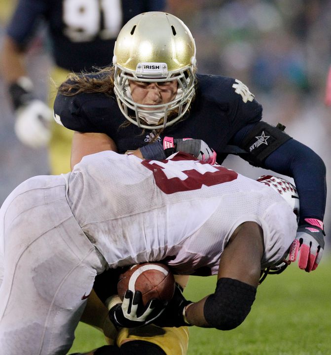 Notre Dame linebacker Dan Fox (48) tackles Stanford running back Stepfan Taylor (33) during the second half. Notre Dame won in overtime 20-13.