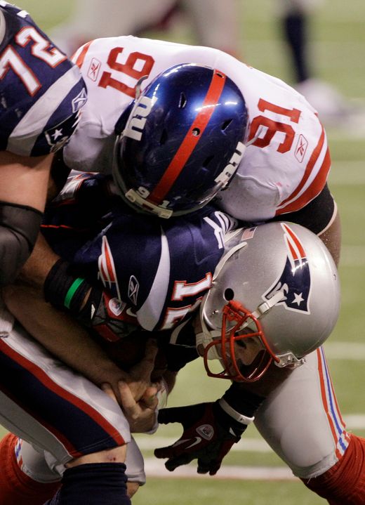 Former Irish defensive end Justin Tuck (91) sacks Tom Brady during the second half of the Super Bowl. (AP Photo/David Duprey)