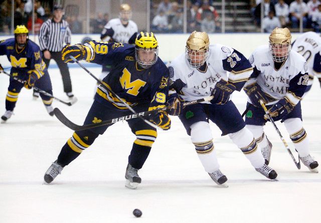 Ryan Guentzel (in white) battles a Michigan player for the puck.  The two will be at it again at the Joyce Center on Feb. 27.