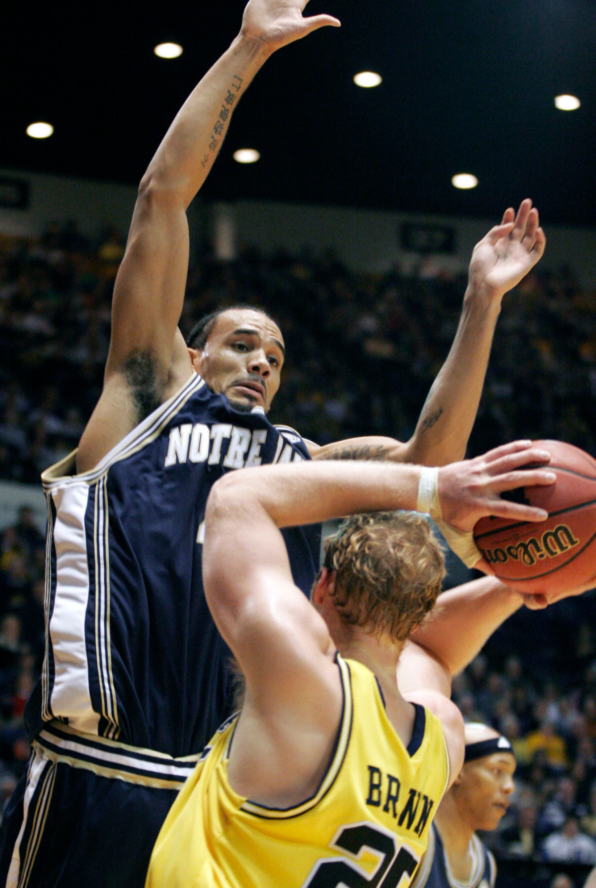 No. 20 Irish Edged By Wolverines Dennis Latimore puts the pressure on Michigan's Graham Brown in the first half Saturday in Ann Arbor.