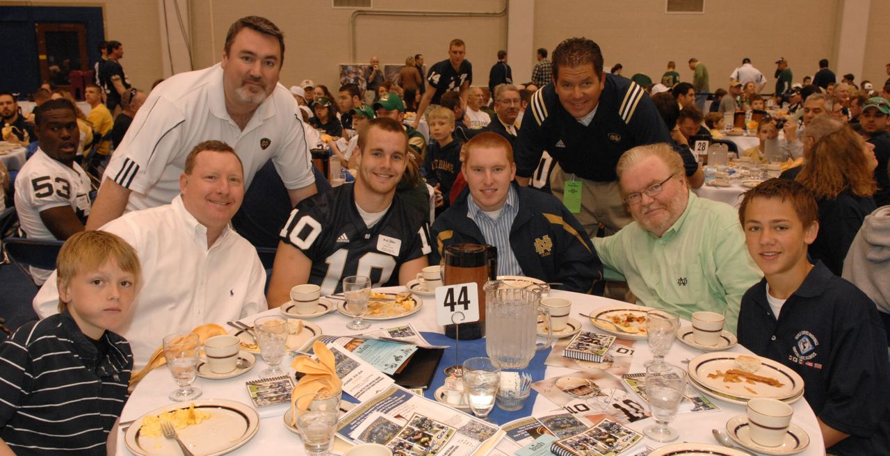 Quarterback Dayne Crist poses for a picture with the fans who joined him for brunch before the Blue-Gold game.