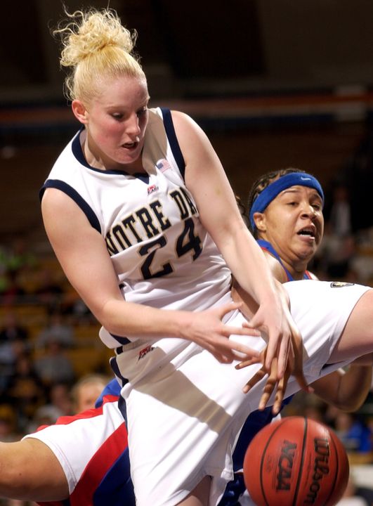 Notre Dame guard Lindsay Schrader (24) grabs a rebound while DePaul forward Caprice Smith (23) defends during the first half of a college basketball game Tuesday Jan. 17, 2006 in South Bend, Ind. (AP Photo/Joe Raymond)