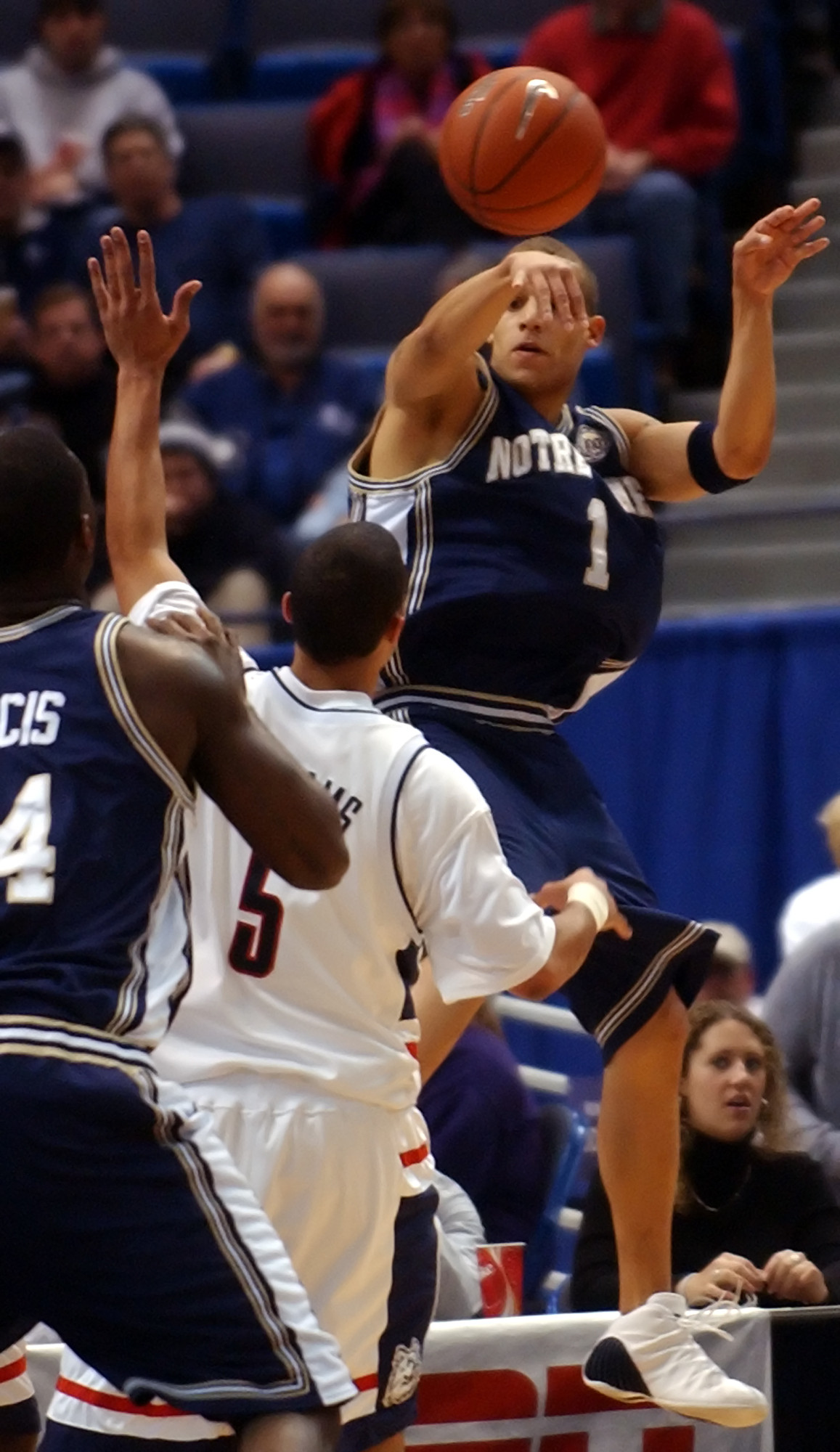 Notre Dame Falls To Connecticut, 88-74 Chris Thomas leaps in the air to pass over Connecticut's Marcus Williams to teamate Torin Francis.