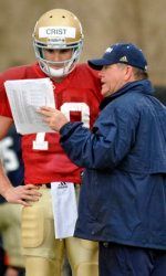 Notre Dame coach Brian Kelly talks to quarterback Dayne Crist