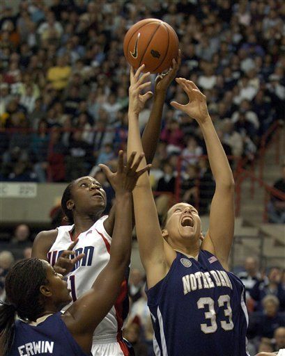 Connecticut's Tina Charles, center, and Melissa D'Amico, right, go for a rebound in the first half.  At left is Crystal Erwin. (AP Photo/Jessica Hill)