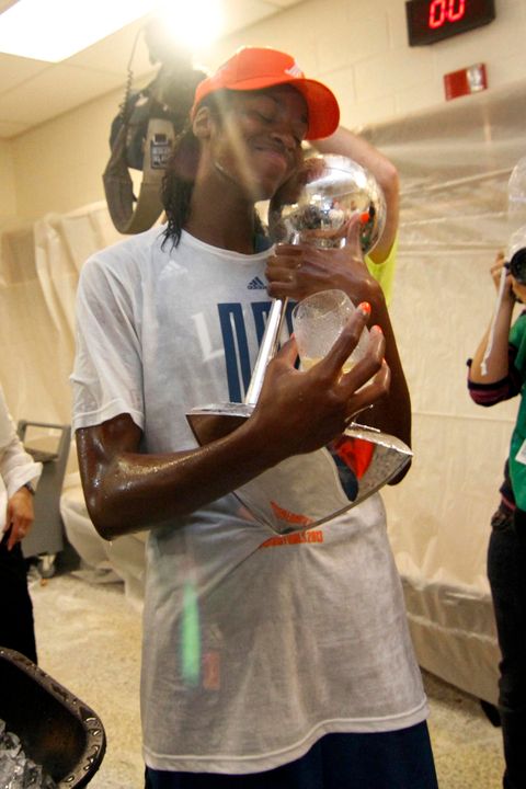 Former Notre Dame All-America forward Devereaux Peters ('11) embraces the WNBA championship trophy after helping the Minnesota Lynx win their second league title in three seasons last October.