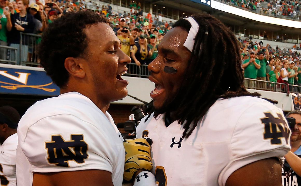 DeShone Kizer (14) celebrates with Jaylon Smith (9) after their game against the Virginia Cavaliers