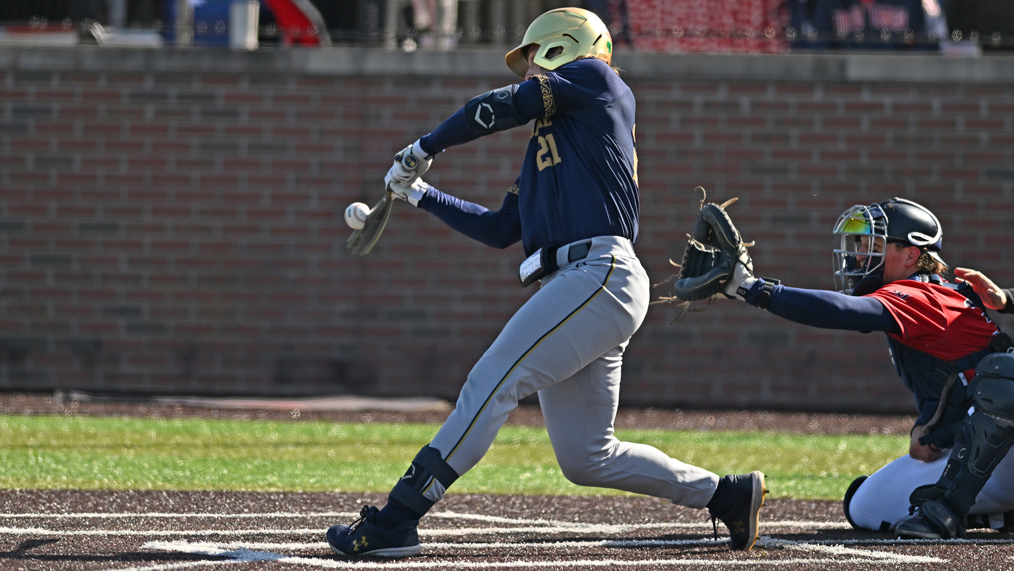 Late-Inning Rally Lifts Irish to Sweep of Bruins Brady Gumpf hits the baseball.
