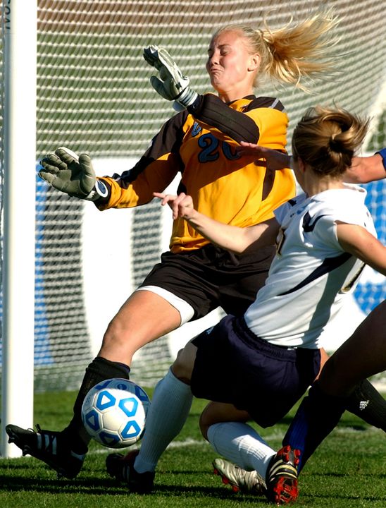 Annie Schefter shoots on UCLA's goalie Valerie Henderson in first half of the 23rd Annual Division I Women's Soccer Championship College Cup finals.
