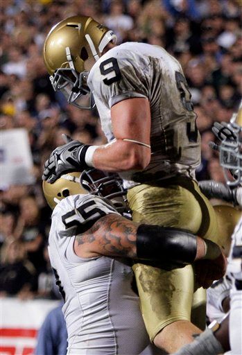 Notre Dame tight end Kyle Rudolph (9) reacts with Notre Dame center Eric Olsen after Rudolph scored on a two-yard touchdown reception during the fourth quarter of an NCAA football game against Purdue in West Lafayette, Ind., Saturday, Sept. 26, 2009. Notre Dame won 24-21.