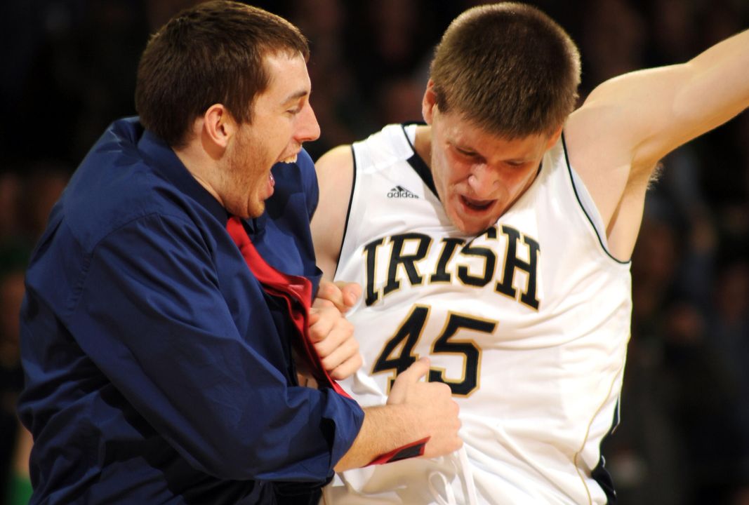Notre Dame forward Jack Cooley, right, hip bumps with red shirt center Garrick Sherman.