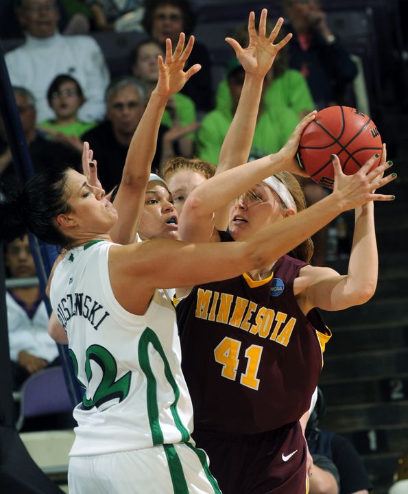 Minnesota's Brianna Mastey is tied up by Notre Dame forward Becca Bruszewski and guard Ashley Barlow in the first half.