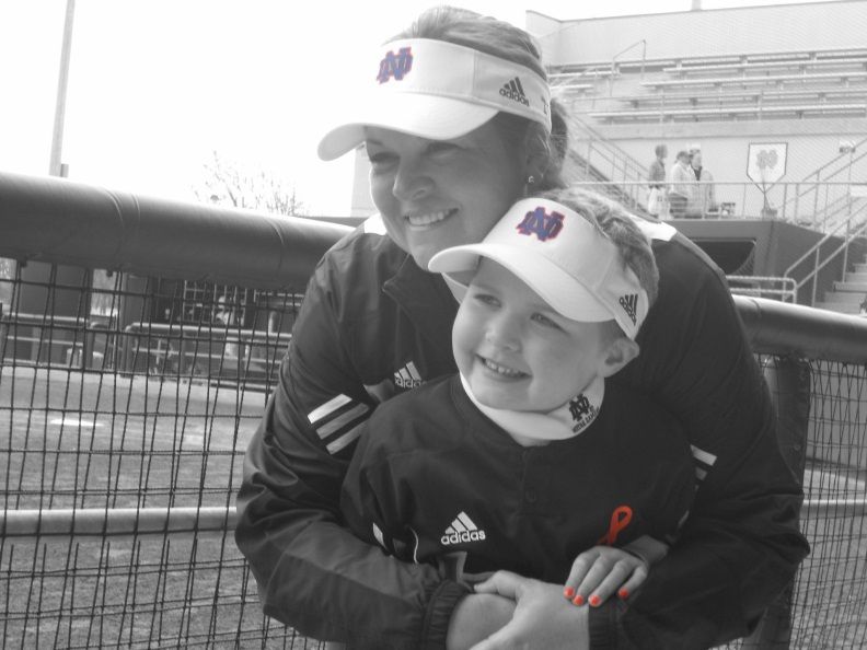 Irish head coach Deanna Gumpf and her daughter, Tatum, on the field before 2011's Strikeout Cancer game against Louisville