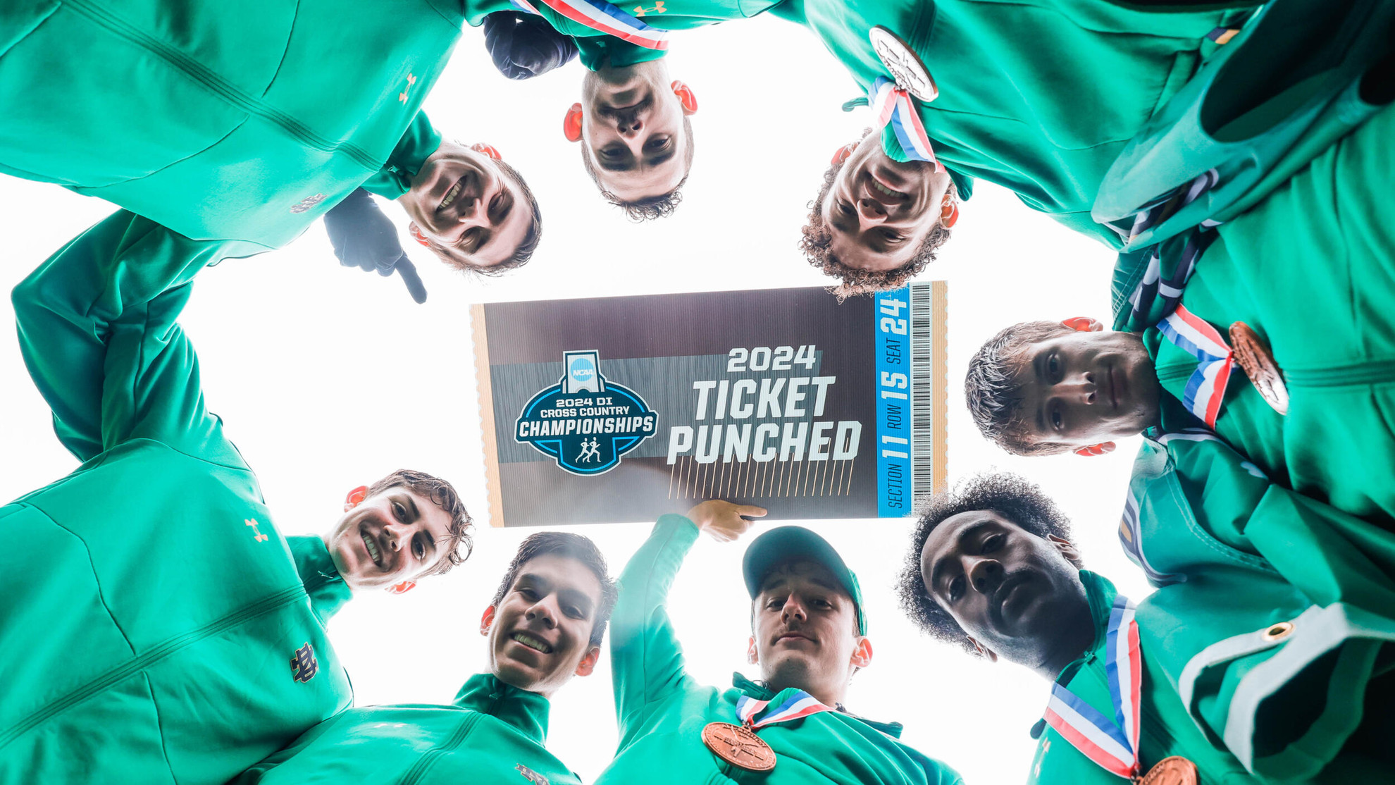Irish Squads Sweep NCAA Great Lakes Regional Races Group celebration with poster.