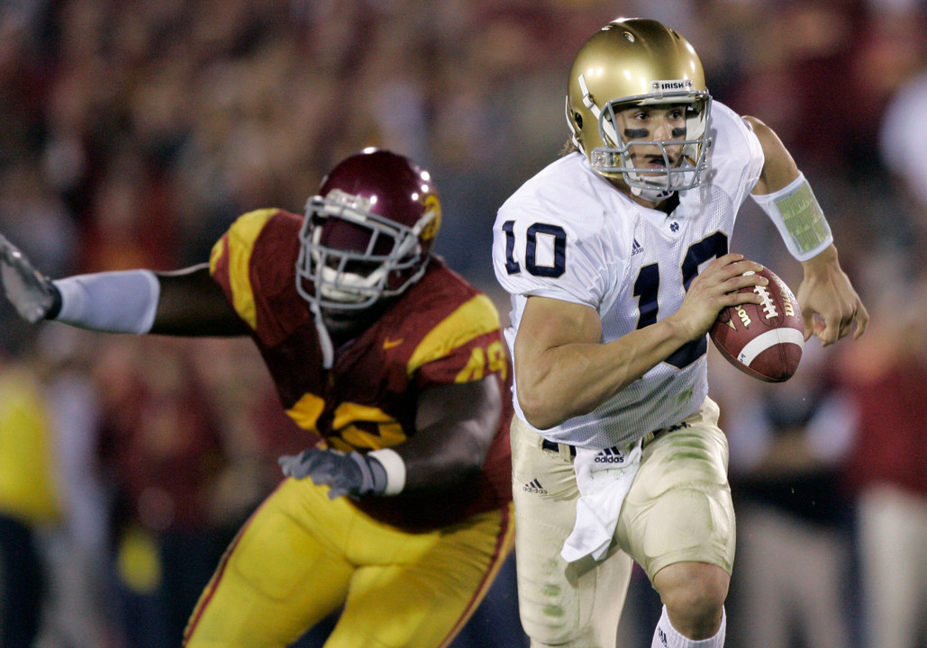 Brady Quinn avoids the USC pass rush during the first half. (AP Photo)