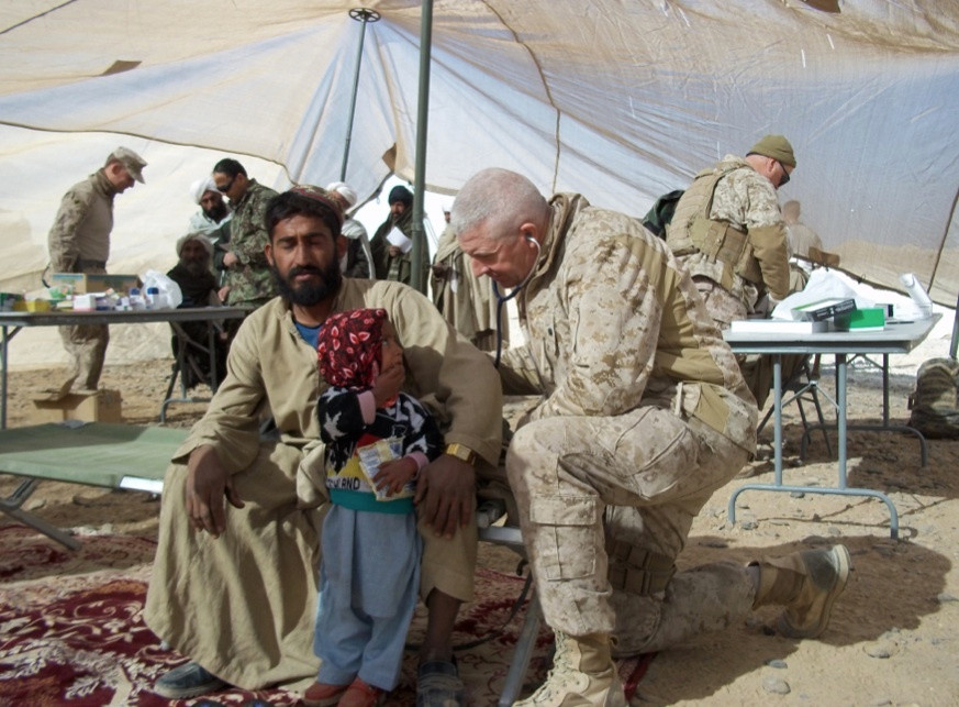Military Medicine Man Roy Seitz ('74, fencing) provides medical care for a young Afghan girl. In addition to his work with U.S. Marines, Seitz aided many innocent Afghan villagers who were persecuted by the Taliban.