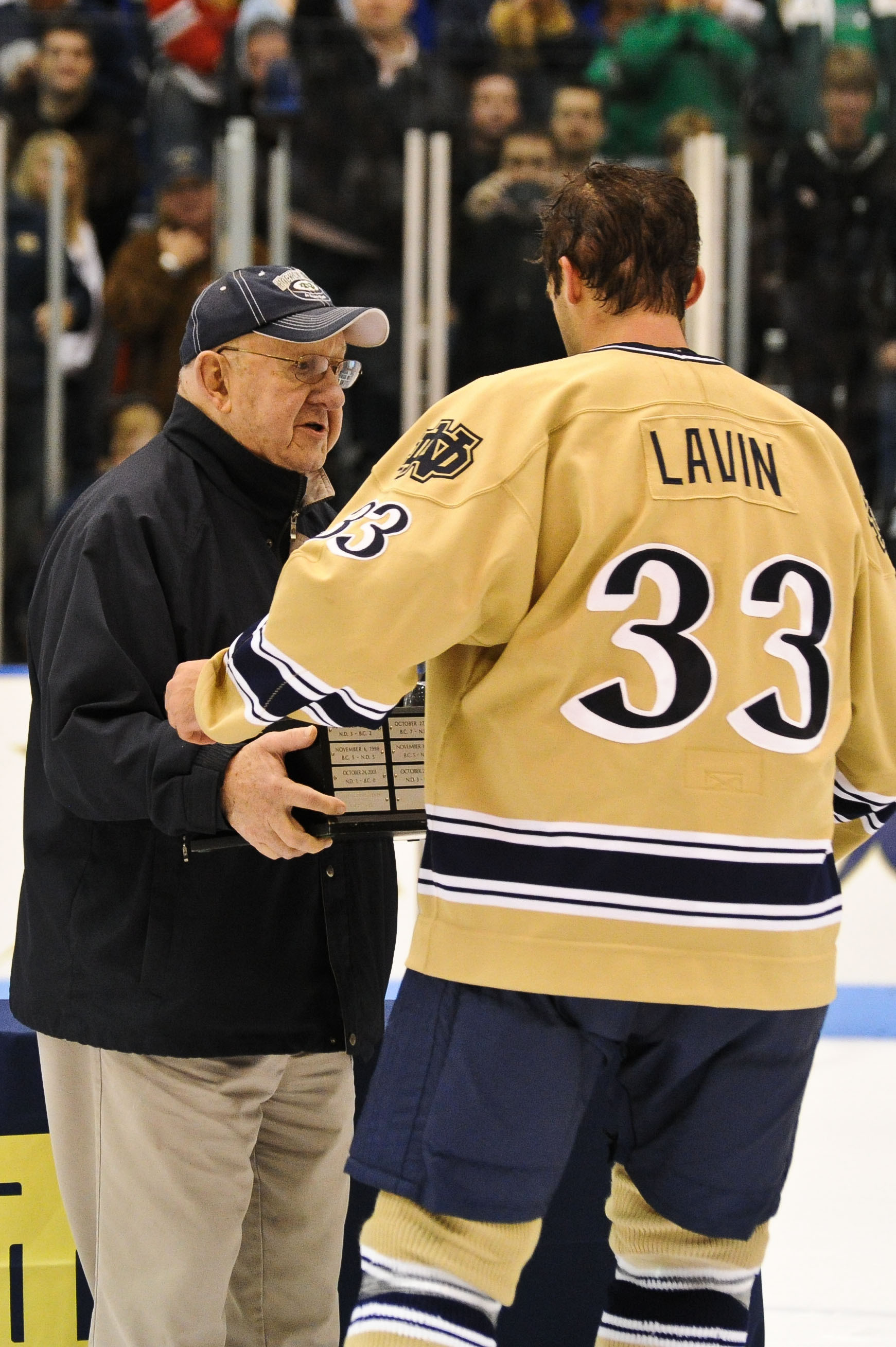 Irish Icers Knock Off No. 1 Ranked Boston College, 2-1 Irish coaching legend, Lefty Smith, presents the John