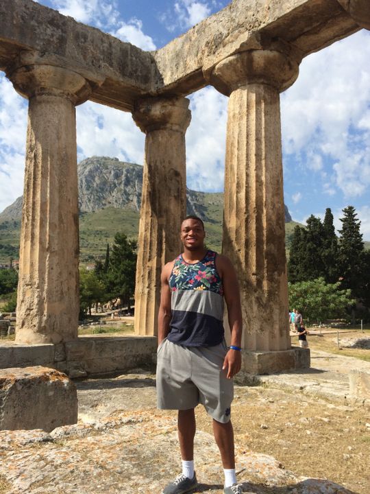 Romeo Okwara in front of the Temple of Hera and Zeus in Ancient Corinth