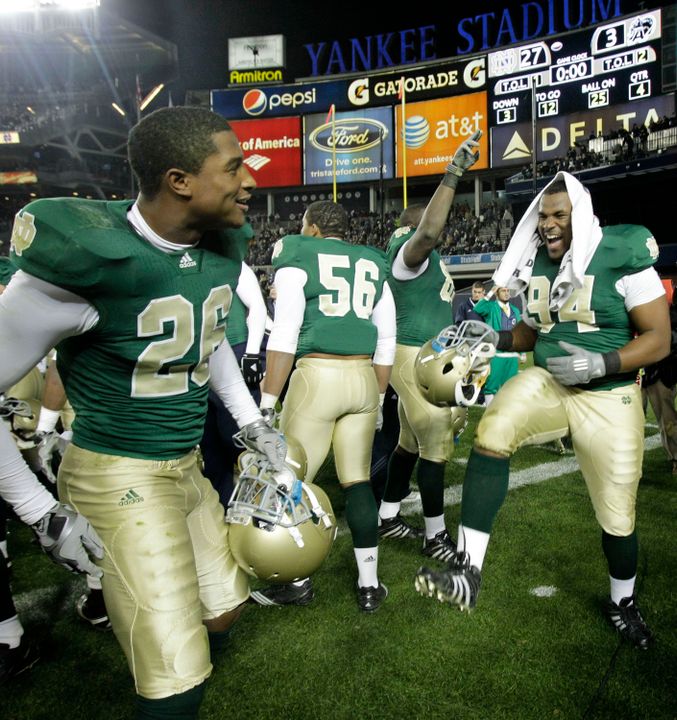 Notre Dame safety Jamoris Slaughter (26), linebacker Kerry Neal (56) and defensive lineman Hafis Williams (94) celebrate Notre Dame's 27-3 victory over Army at Yankee Stadium in New York, Nov. 20, 2010.