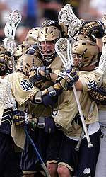 Giordano’s Fifth Goal Gives #11 Irish 14-13 Overtime Win Against Air Force Senior co-captain Brian Giordano (center) was mobbed by his teammates after his game-winning goal on Sunday. (photo by Matt Cashore)