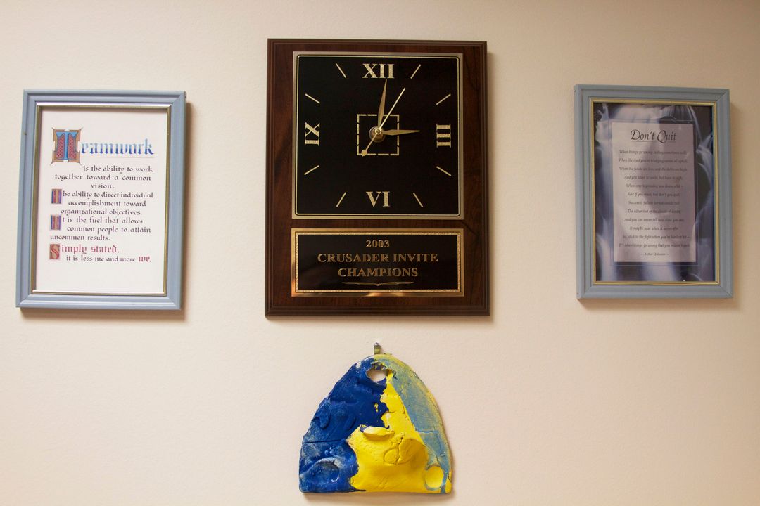 This bright blue-and-gold-painted art piece (made by his daughter, Ali, many years ago as a kindergartener) is among the many notable items that line the office walls for Notre Dame women's cross country coach Tim Connelly.