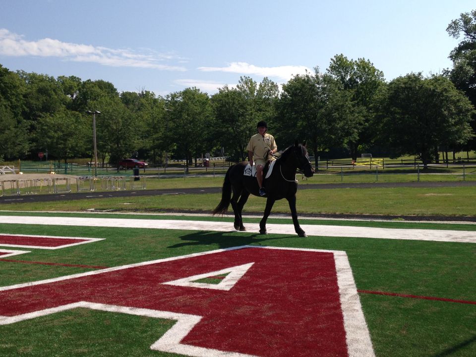 Head coach Brian Kelly rode one of Culver Academies' famed black horses onto the practice field on Friday.