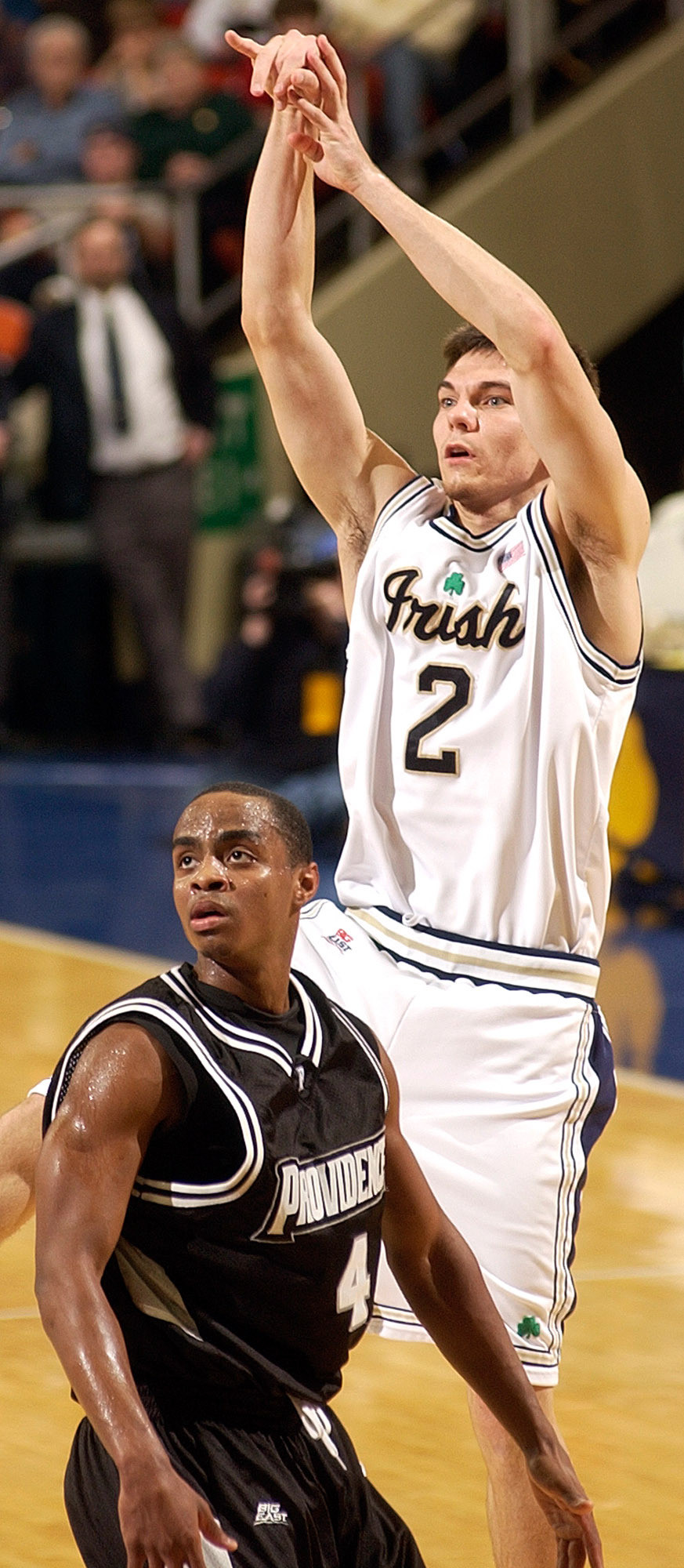 Irish Dominate Providence 92-77 Chris Quinn watches his shot over Providence guard Sharaud Curry.
