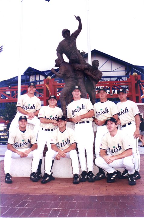 Members of the 2002 team pose in front of Rosenblatt Stadium.