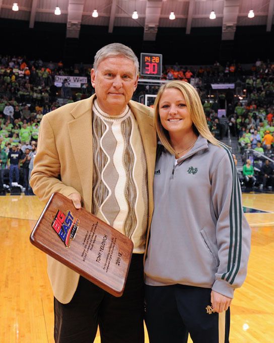 Notre Dame assistant athletics director/women's soccer administrator Tony Yelovich (seen here with women's soccer co-captain Jessica Schuveiller) was presented with an award in honor of National Girls and Women in Sports Day during Monday night's women's basketball game vs. Tennessee at Purcell Pavilion.