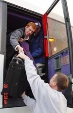 Sophomore Louis Cavadini (top), one of the authors of the first Ireland diary, helps assistant coach Matt Tallman unload baggage from the emergency exit compartment of the bus in Dublin.