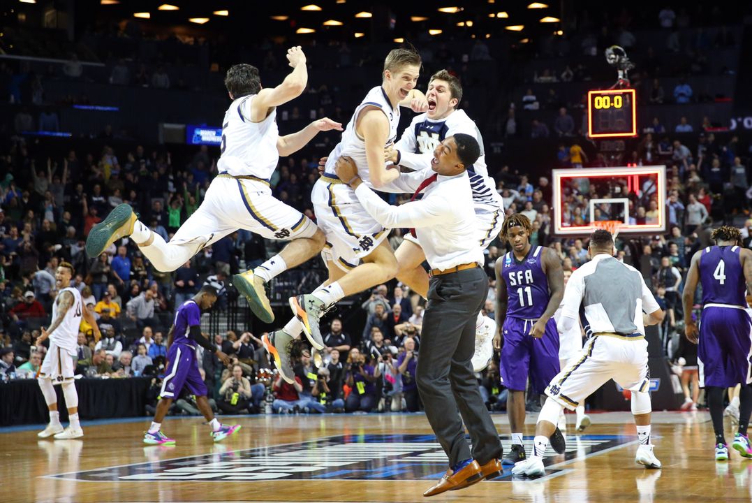Mar 20, 2016; Brooklyn, NY, USA; Notre Dame Fighting Irish guard Rex Pflueger (middle) celebrates with his teammates as time expires after tipping in the winning basket against the Stephen F. Austin Lumberjacks in the second round of the 2016 NCAA Tournament at Barclays Center. Credit: Anthony Gruppuso-USA TODAY Sports