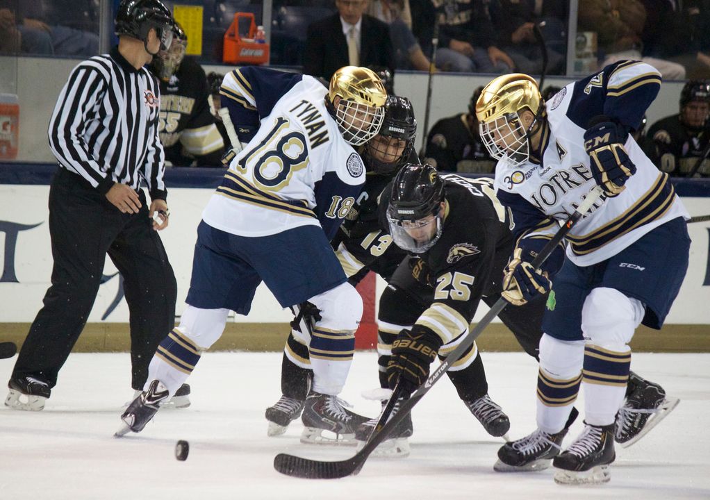 T.J. Tynan (left) and Bryan Rust (right) battle Western Michigan in the season opener on Oct. 11.