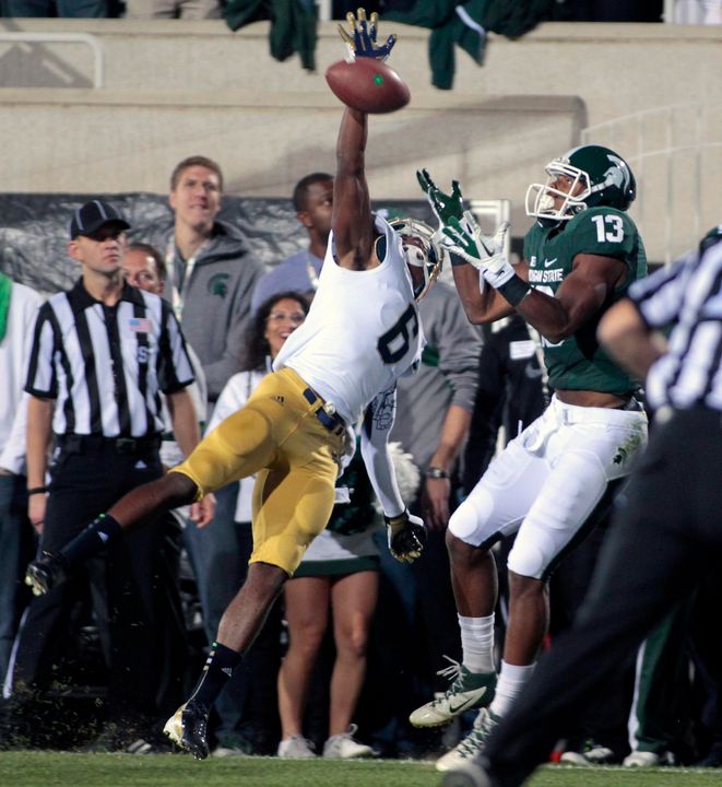 KeiVarae Russell knocks away a pass intended for Michigan State's Bennie Fowler in last year's game.