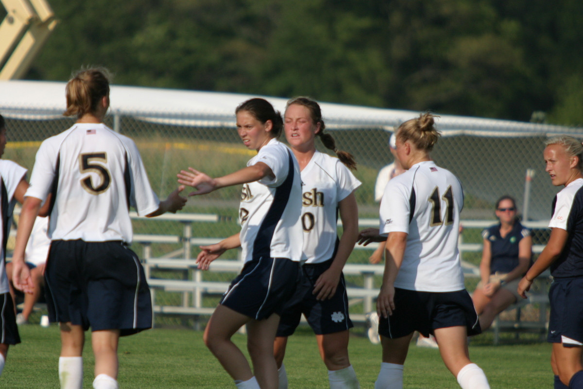 Cinalli’s Pair Of Goals Pace Second-Ranked Irish To 3-1 Exhibition Win Over 11th-Ranked Virginia Kerri Hanks (right) offers congratulations to Amanda Cinalli (#5) after her goal that capped the 3-1 win over Virginia (photos by Pete LaFleur).