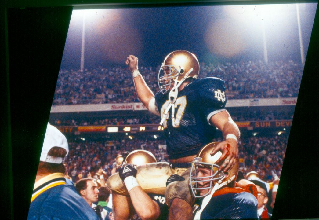 Led by All-America linebacker and team co-captain Ned Bolcar, Notre Dame planted its flag atop the college football mountain for the 11th time in 1988, clinching the national championship and a perfect 12-0 season with a 34-21 win over West Virginia at the Sunkist Fiesta Bowl in Tempe, Ariz.