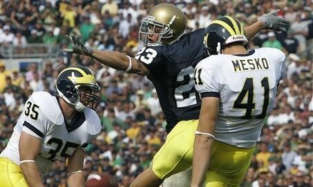 Notre Dame defensive back William David Williams, center, nearly blocks the punt of Michigan punter Zoltan Mesko (41) during the first quarter.  (AP Photo/Michael Conroy)