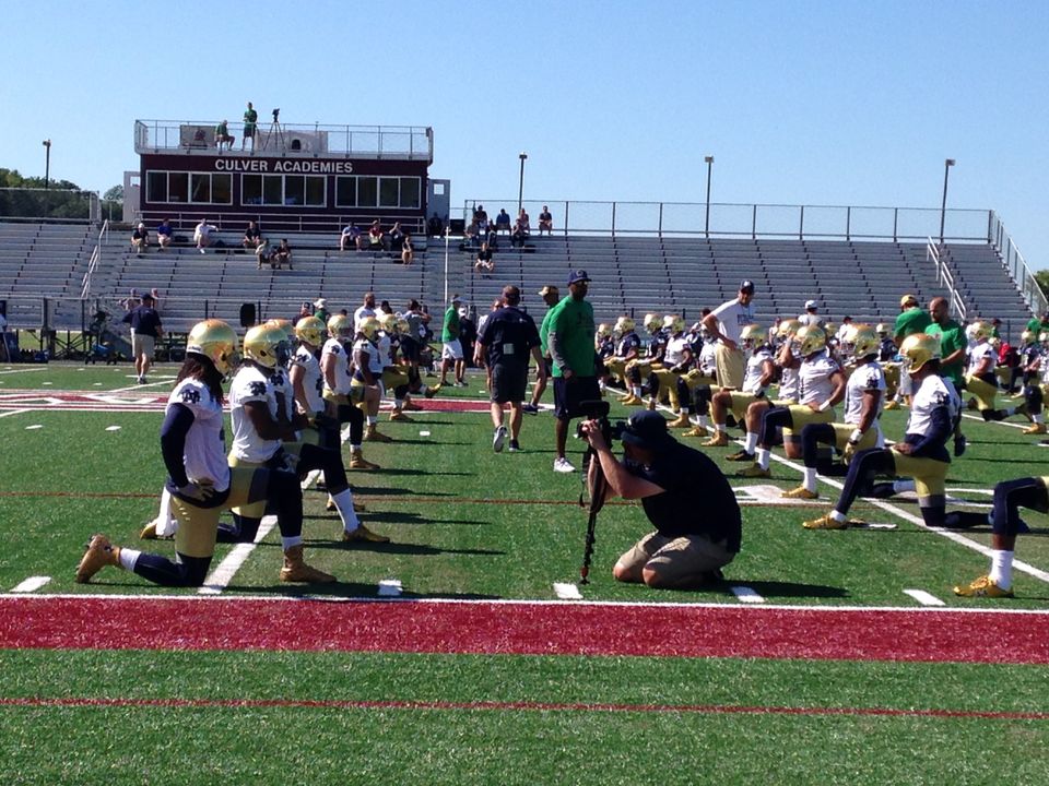 Notre Dame's seniors lead their peers in stretching before the first preseason practice at Culver Academies.