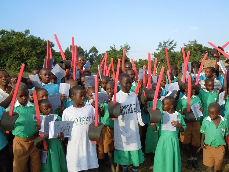 Kids Make Fencing History In Uganda The children of Kkindu raise their foam swords as they prepare to begin the fencing tournament.