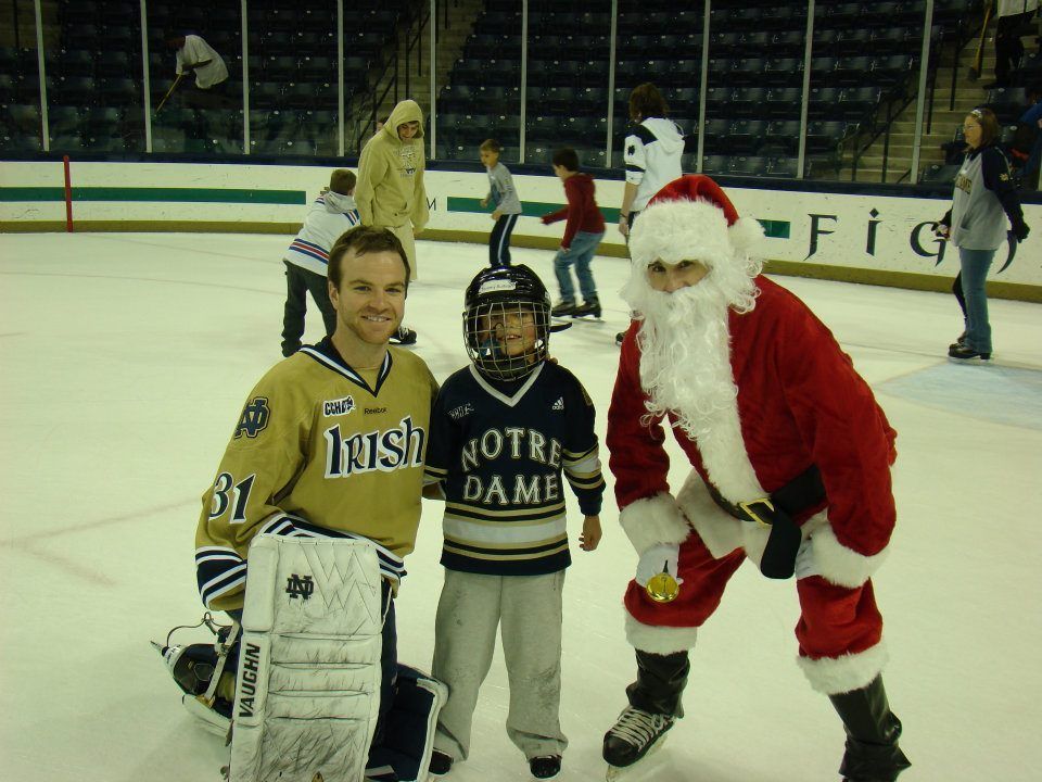 Goaltender Joe Rogers with an Irish fan and Santa Claus at the 2011-12 Skate with the Irish.