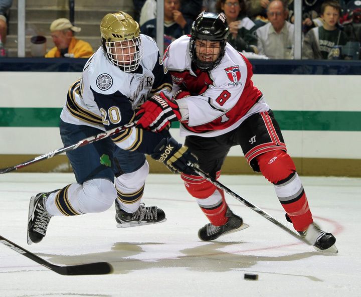 Junior right wing Kevin Nugent battles for a loose puck against RPI.