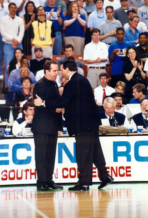 Notre Dame head coach Mike Brey shakes hands with Duke head coach Mike Krzyzewski before their teams' NCAA Tournament second-round game in 2002 in Greenville, S.C.